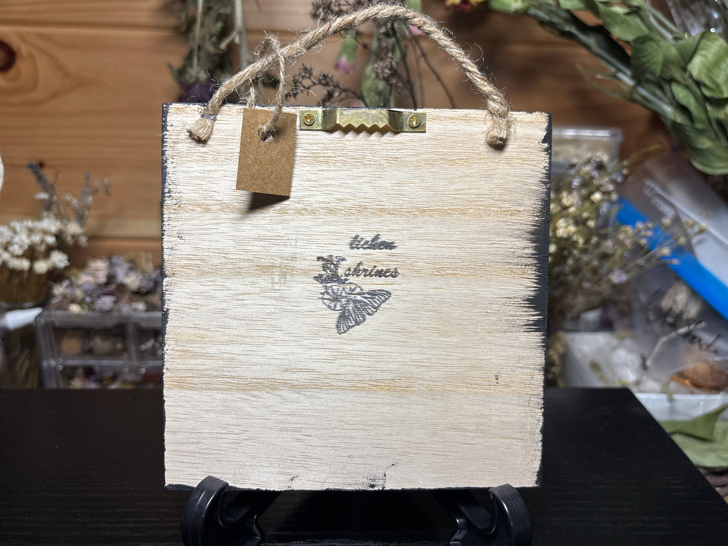 mummified opossum tail floral wooden hanging plaque